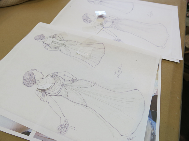architectural and romatic wedding dress sketches taped with edits and changes