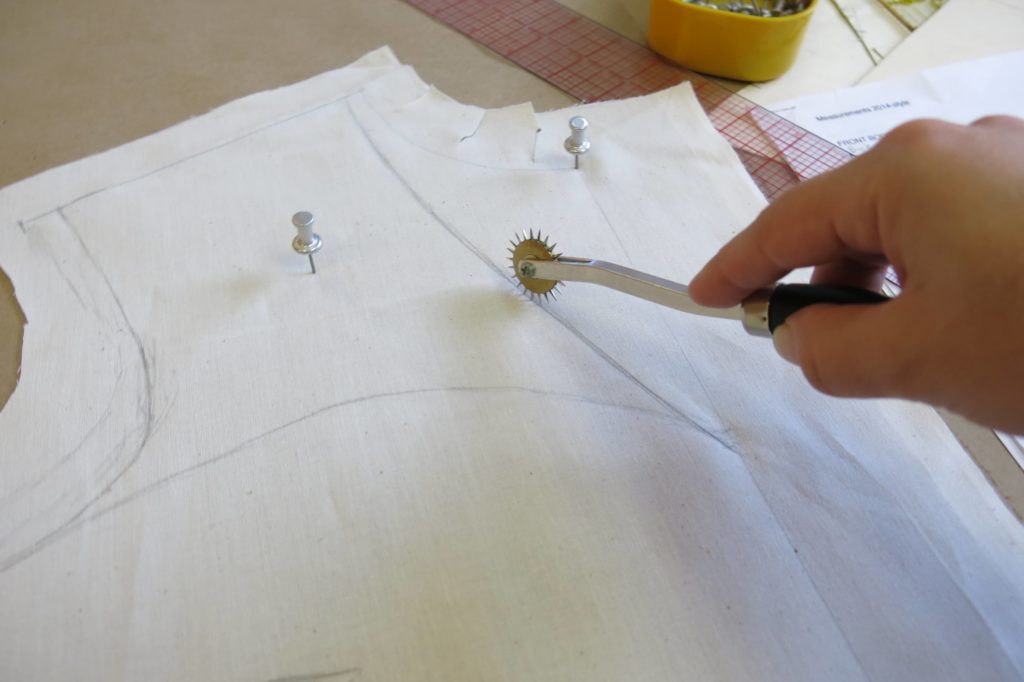 Using a spiky wheel to transfer the rough drape to the paper while Patternmaking for Cameron's custom wedding overdress by Brooks Ann Camper Bridal Couture