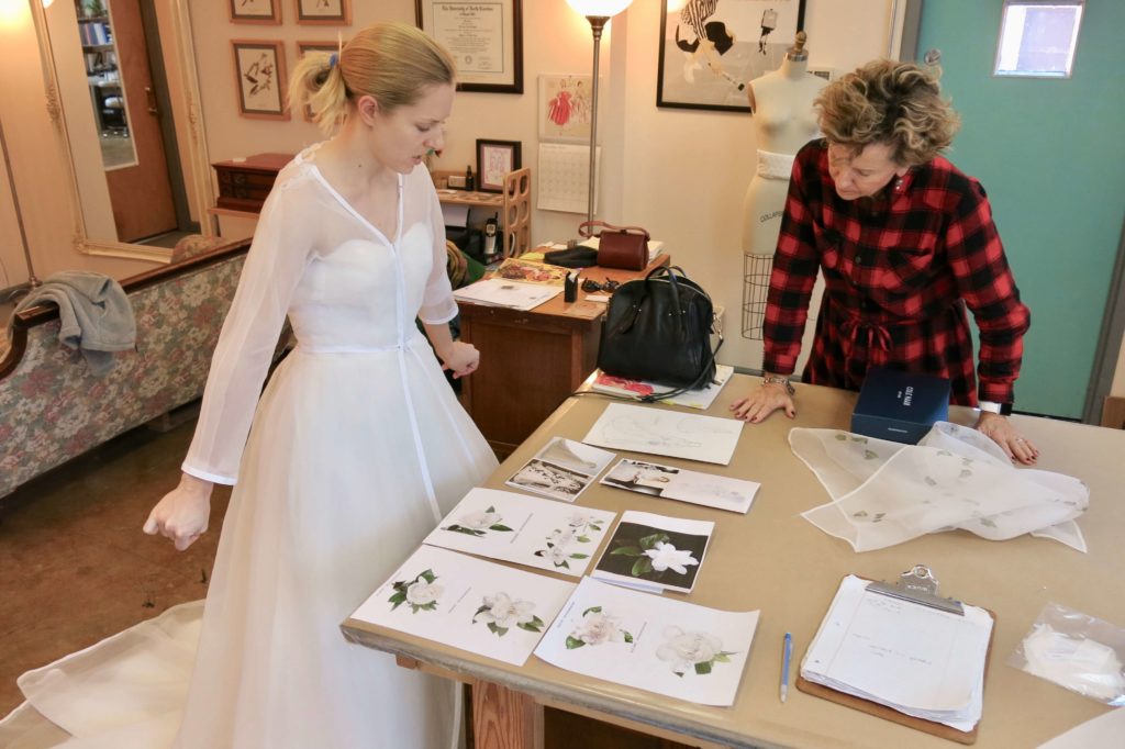 Looking at fabric samples during Cameron's first mockup fitting with Brooks Ann Camper Bridal Couture